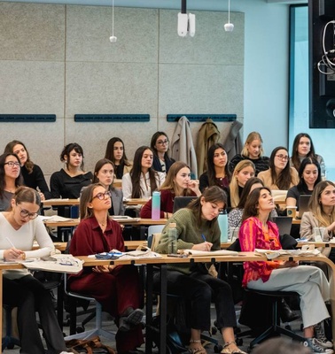 A classroom filled with students attentively engaging in a lecture.