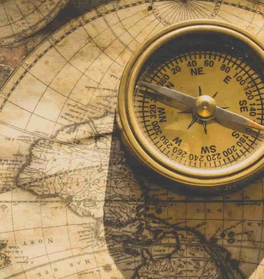 A compass on an ancient world map.
