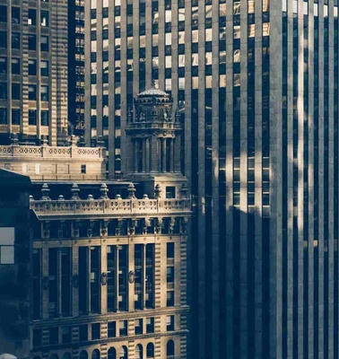 A close-up view of dense urban skyscrapers with contrasting architectural styles.