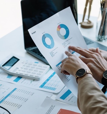 Two people discussing charts and graphs during a business meeting.