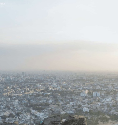 Aerial view of a densely populated city under hazy sky conditions