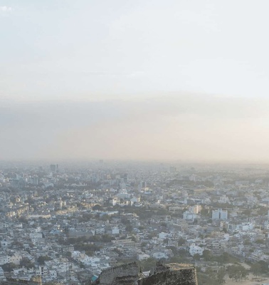 Aerial view of a densely populated city under hazy sky conditions