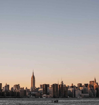 A panoramic view of a city skyline at sunset.
