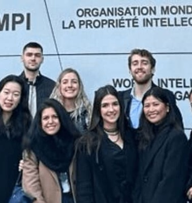 A group of people standing in front of the World Intellectual Property Organization headquarters.