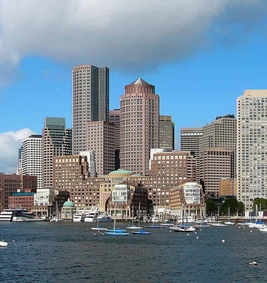 A panoramic view of a modern city skyline by the waterfront.