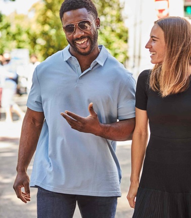 Happy student walking on the street