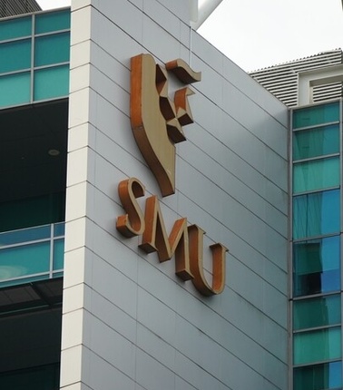 A modern building with a prominent logo displaying the letters SMU.