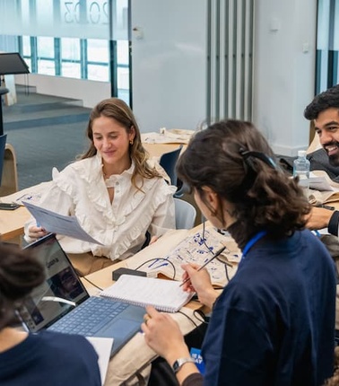 A group of people engaging in a collaborative work session at a modern office space.