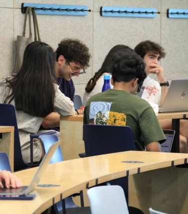 A group of students working collaboratively in a classroom setting.