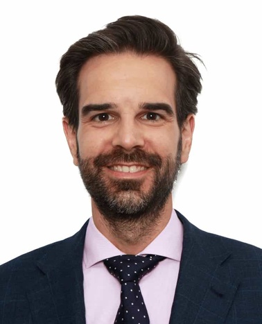 Portrait of a smiling man in a suit with a tie.