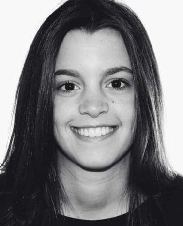 Black and white portrait of a smiling young woman with long straight hair.