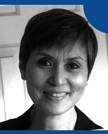 A black and white portrait of a smiling woman with short hair, featuring a blue graphic element in the top corner.