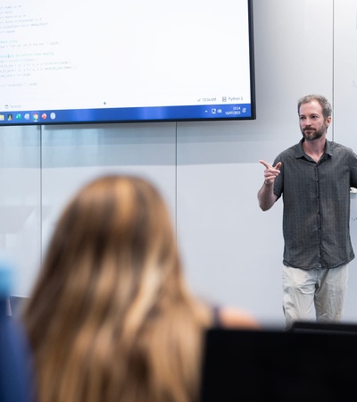 A teacher presenting a lesson in front of a classroom.