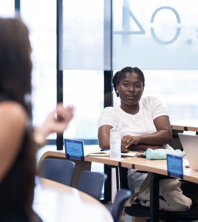 A focused student listens intently during a classroom discussion.