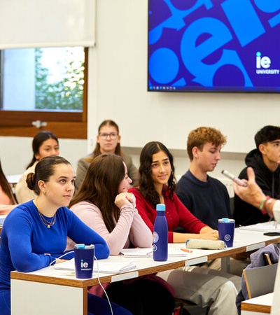 A group of students listening to a lecture in a classroom at IE University.