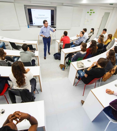 A group of students attending a presentation in a modern classroom.