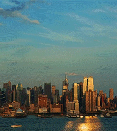 A stunning sunset view of a city skyline by the water.