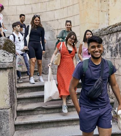 A group of people walking down a stairway in a casual setting.