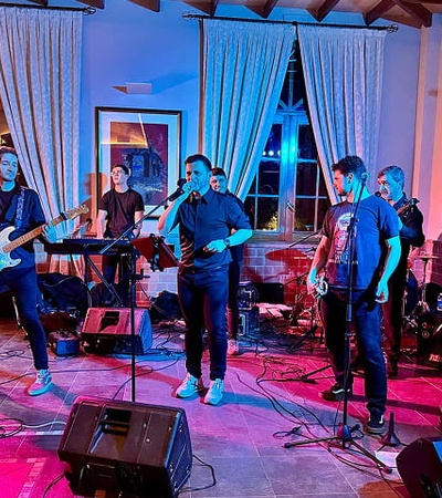 A live music performance by a band in a vibrant, colorful setting.