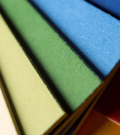 Close-up view of stacked colorful paper sheets.