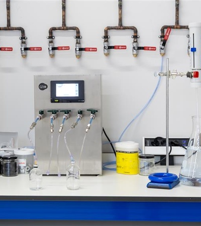 A modern laboratory setup featuring various glassware and equipment for chemical experiments.