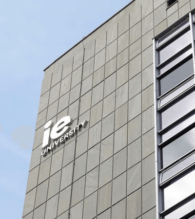 A modern university building with a prominent sign.