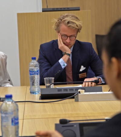 A group of individuals engaged in a serious discussion during a meeting.