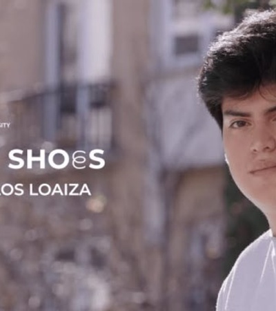 A promotional banner showing a young male with text indicating a feature called 'In Their Shoes' with Carlos Loaiza.