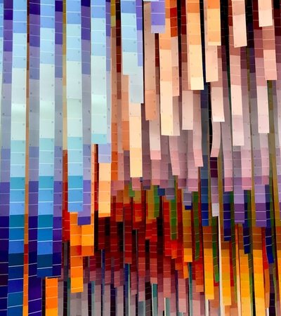 Abstract pixelated image with a blend of various vibrant colors arranged vertically.