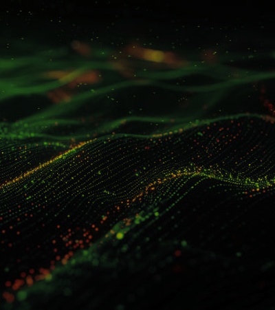 Abstract image of a digital landscape with glowing green and orange dots on undulating waves, simulating a network or data flow.