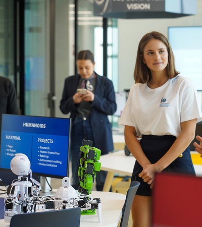 A group of students presenting robotic projects at an exhibition.