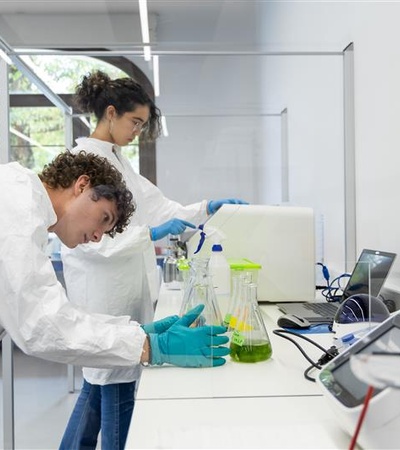 Two young scientists are conducting experiments in a modern laboratory.