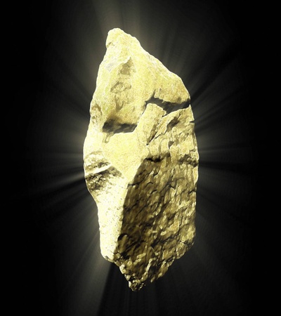 A shining golden rock with a textured surface.