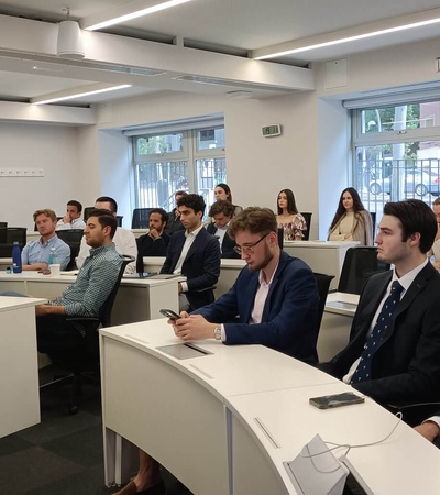 A group of professionals attending a presentation in a modern conference room.