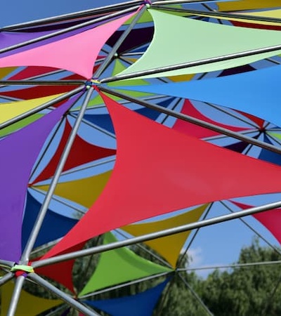 Colorful geometric canopy constructed with multicolored triangular fabrics and a metal frame