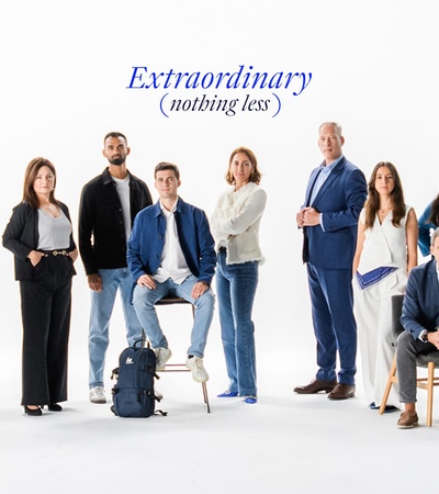A diverse group of people posing together in a professional setting.