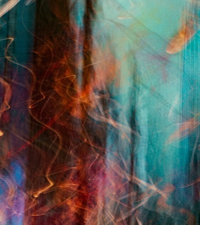 Abstract blurred motion of lights with a blend of blue, orange, and white colors creating a dynamic and artistic effect.