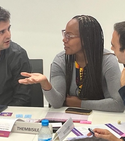 A group of professionals engaged in a discussion at a conference table.