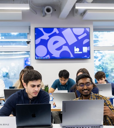 A classroom filled with students working on laptops.