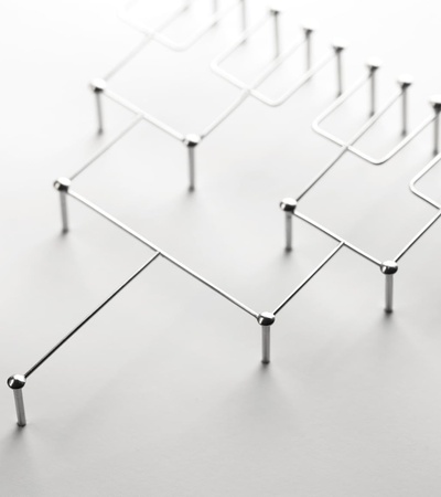 A minimalist metal structure composed of interconnected lines and rods.