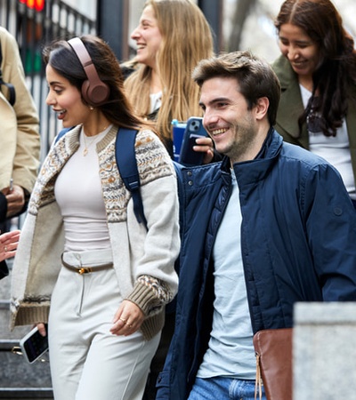 A group of young people enjoying their time outdoors while walking down the stairs.