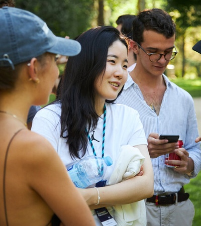 IE Graduate Summer School student outside speaking with classmates