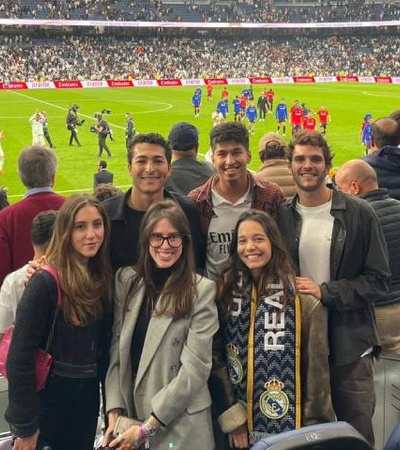 A group of friends enjoying a football match at a stadium.