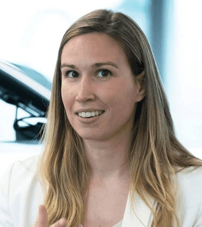 A businesswoman in an office environment, looking attentive during a meeting.