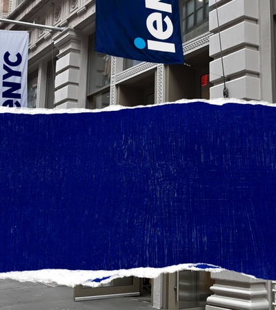A street view showcasing a building facade with a blue and white sign that reads 'iemNYC'.