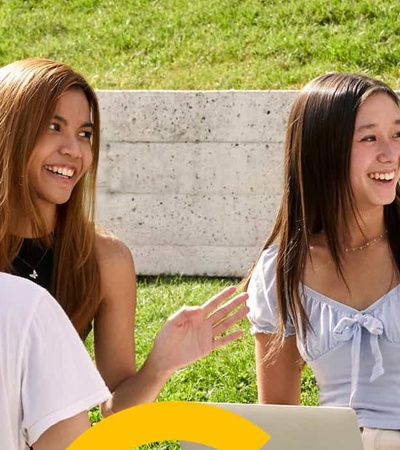 A group of young people enjoying a lively conversation outdoors.