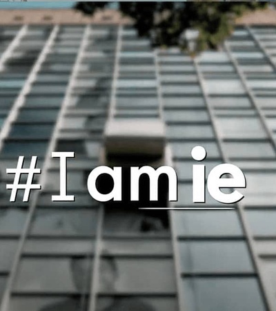 A blurred image of a building facade with the hashtag #Iamie prominently displayed.