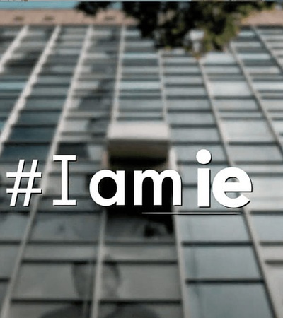 An image featuring a blurred building facade with the hashtag '#Iamie' in focus.