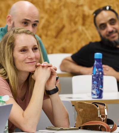 A group of people attentively listening during a presentation.
