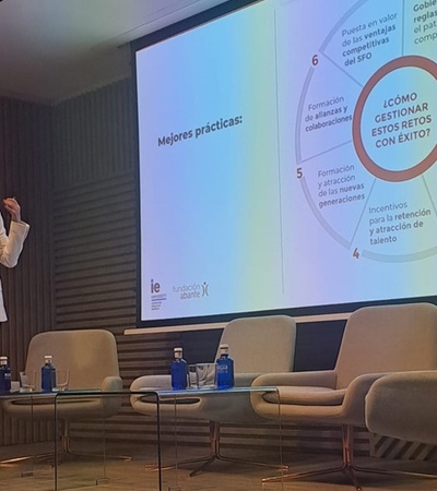 A speaker presenting best practices for managing risks successfully at a conference.